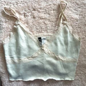 Cream tank top with adjustable straps and lace trim